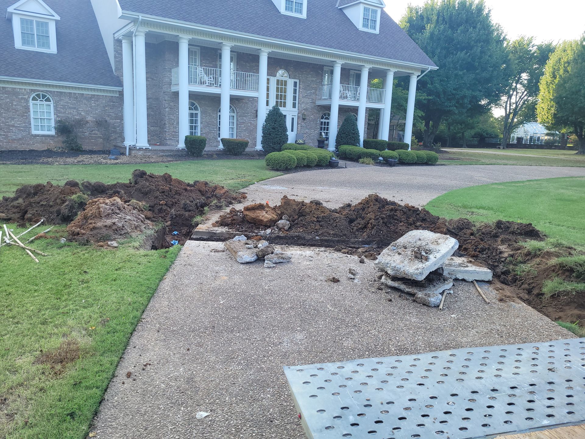 A large house with a lot of dirt in front of it.