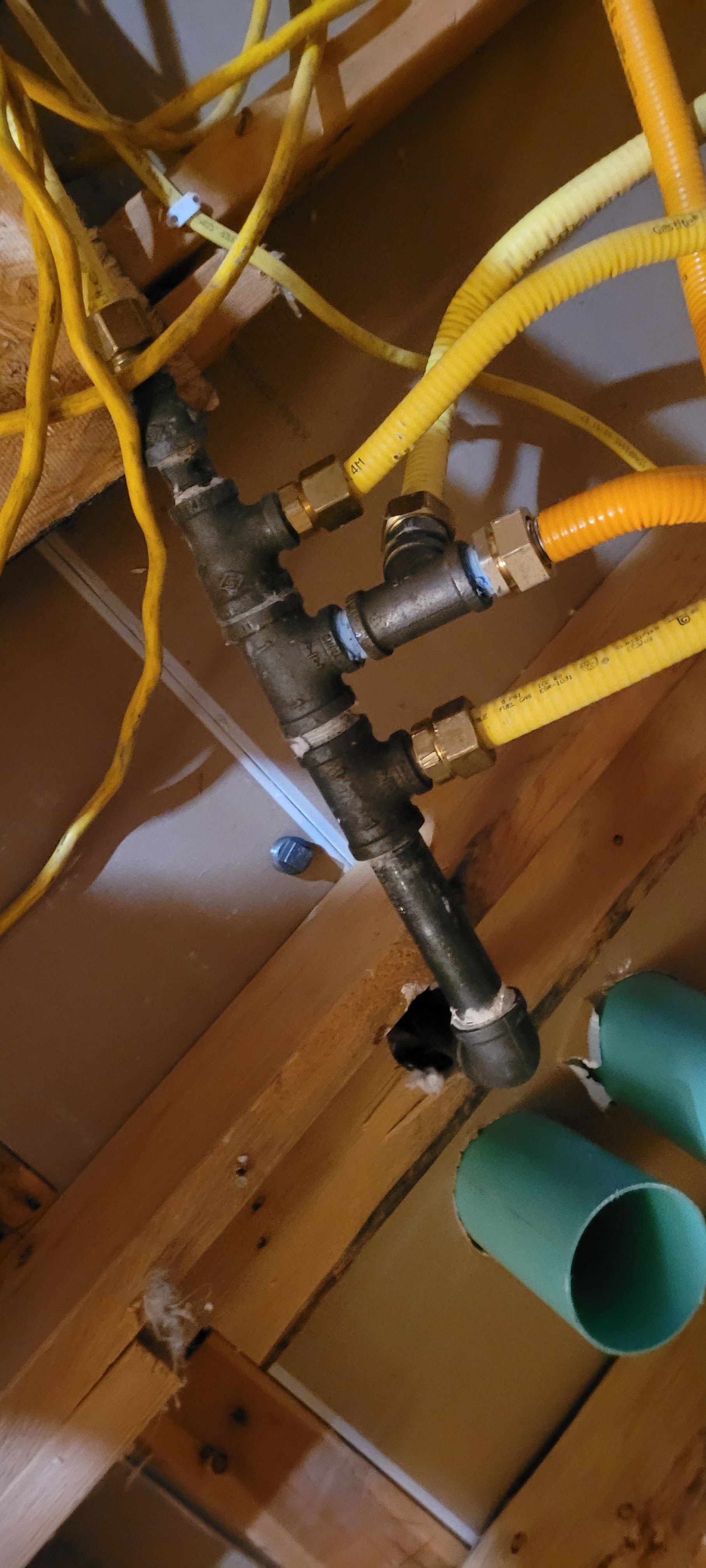 A bunch of pipes are hanging from the ceiling in a room.