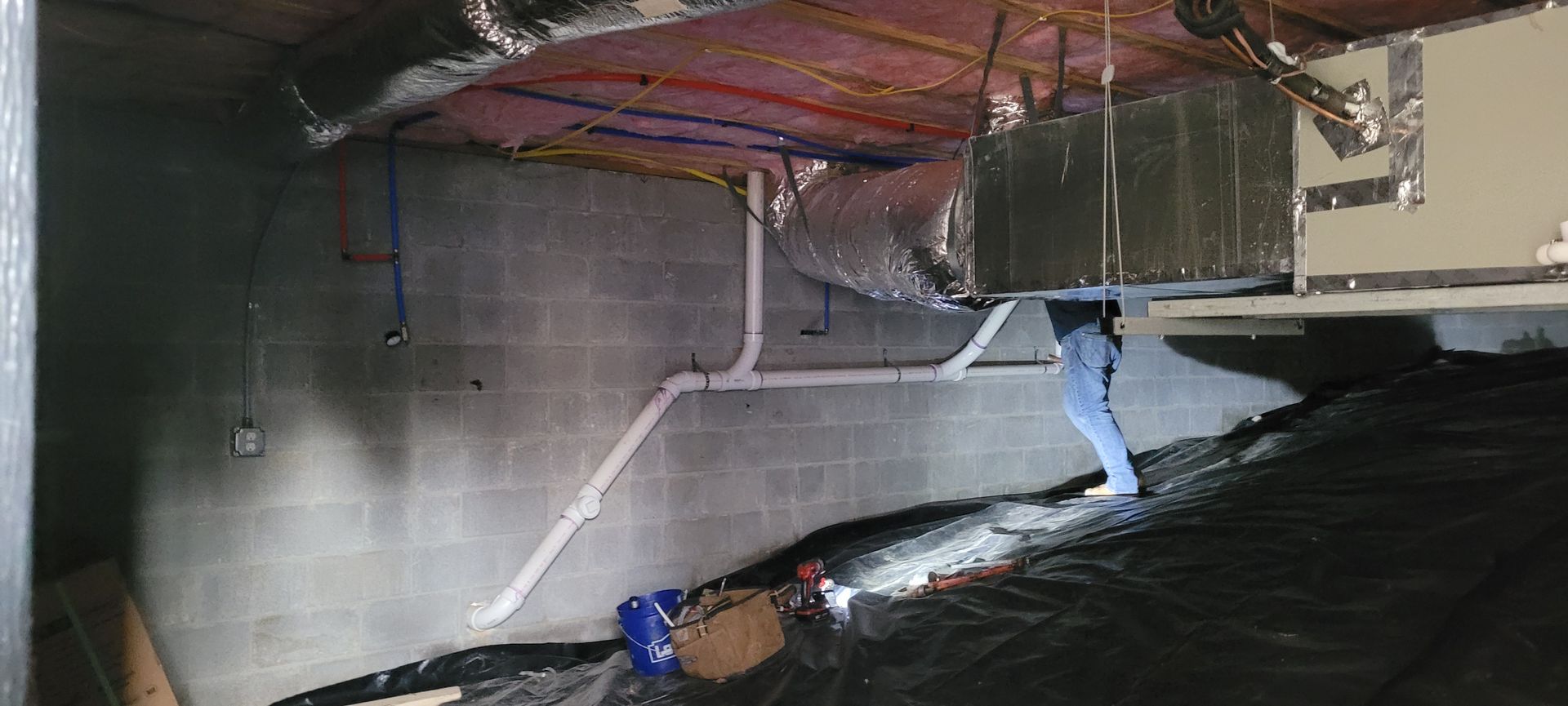 A flooded basement with a lot of water coming out of the ceiling.