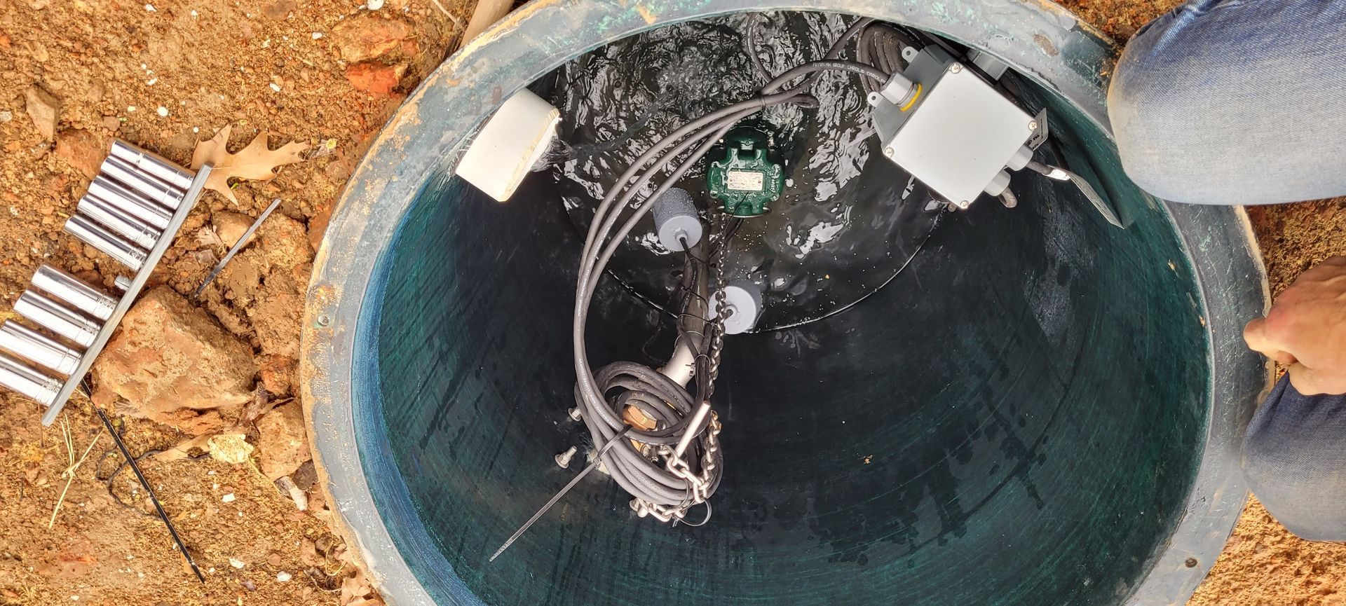 A person is sitting in a bucket of water.