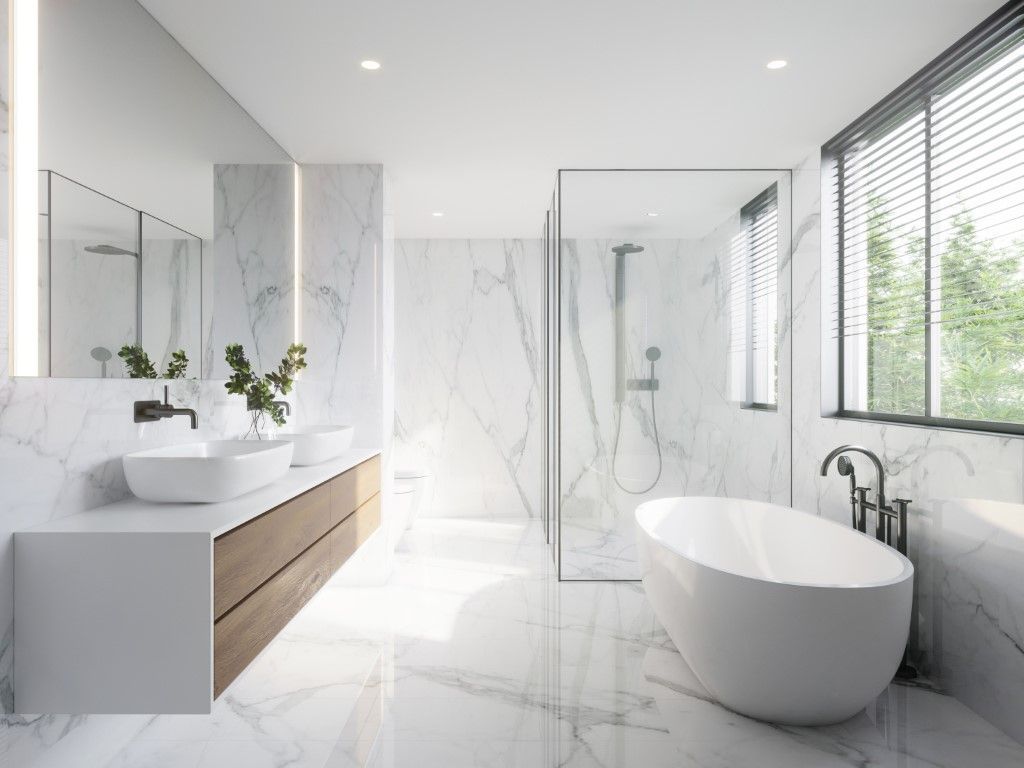 A bright white open concept modern bathroom with freestanding oval tub, floating double vanity with vessel sinks, and shower.