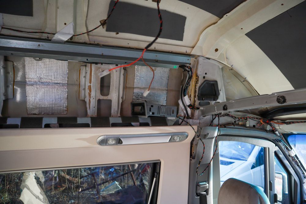 Interior of a van under renovation, showing insulation and exposed wiring along the walls and ceiling. — Pete's Auto Electrical in Cranbourne, VIC