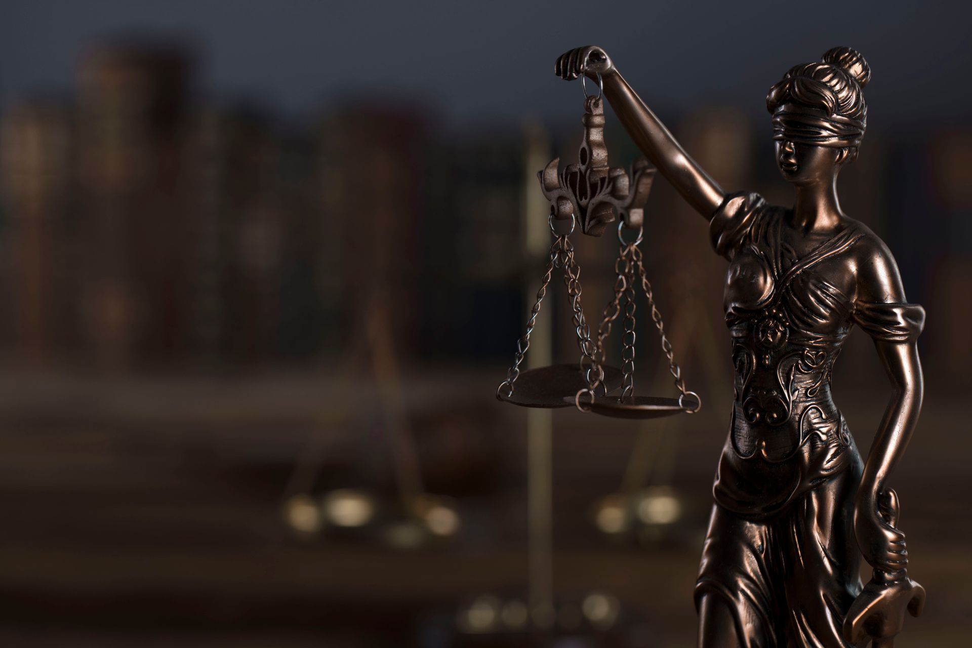 Lady Justice statue holding scales of justice symbolizing law and fairness.