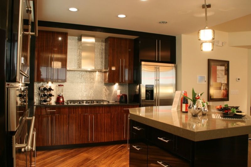 Modern kitchen with brown cabinetry, stainless steel appliances, and island.