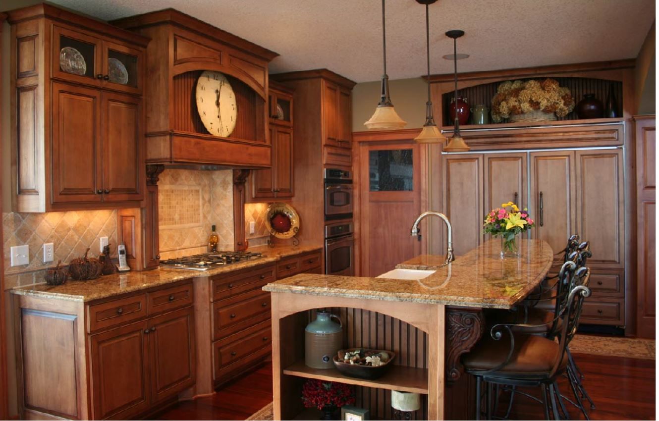 Wooden kitchen with island, cabinets, granite countertops, and recessed lighting.