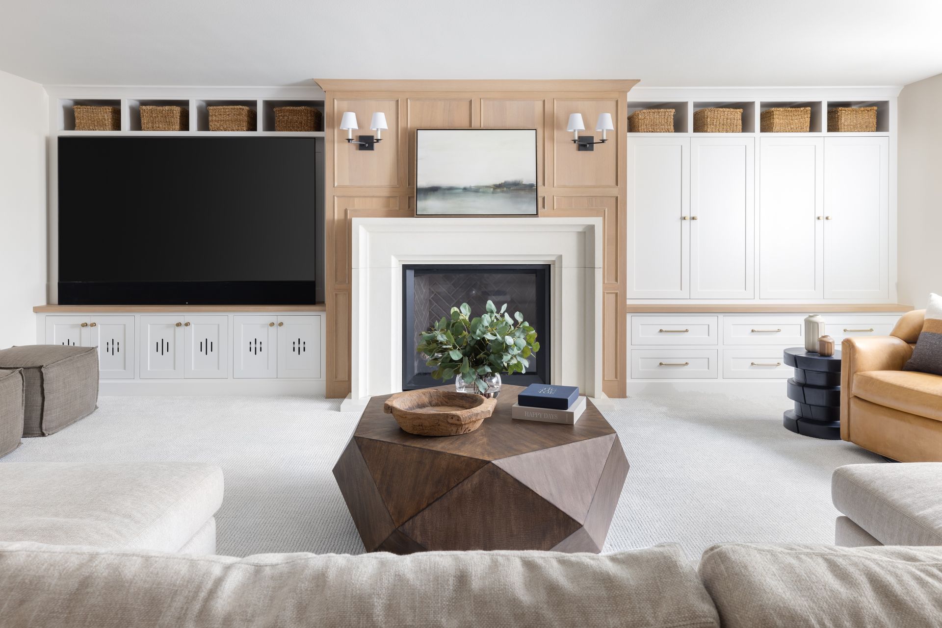 Living room with built-in cabinetry, fireplace, and geometric coffee table. Neutral color scheme, modern design.