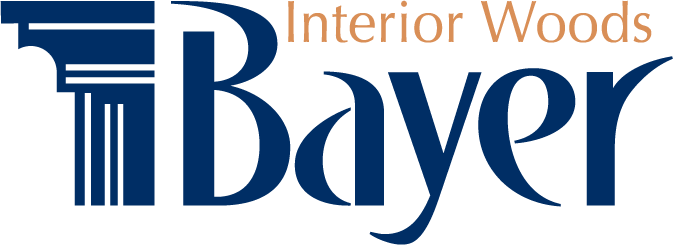 Logo for Interior Woods Bayer. Features a column graphic and stylized "Bayer" in blue. Text "Interior Woods" in brown.