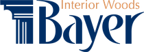 Logo for Interior Woods Bayer. Features a column graphic and stylized "Bayer" in blue. Text "Interior Woods" in brown.