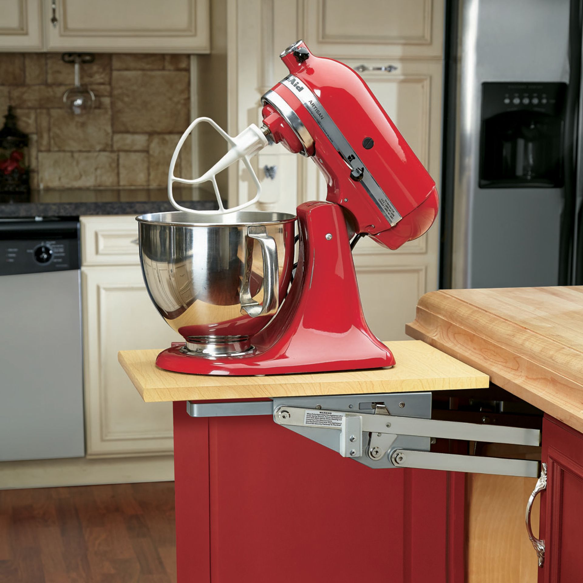 Red stand mixer on a pull-out shelf, mounted in a red kitchen cabinet.