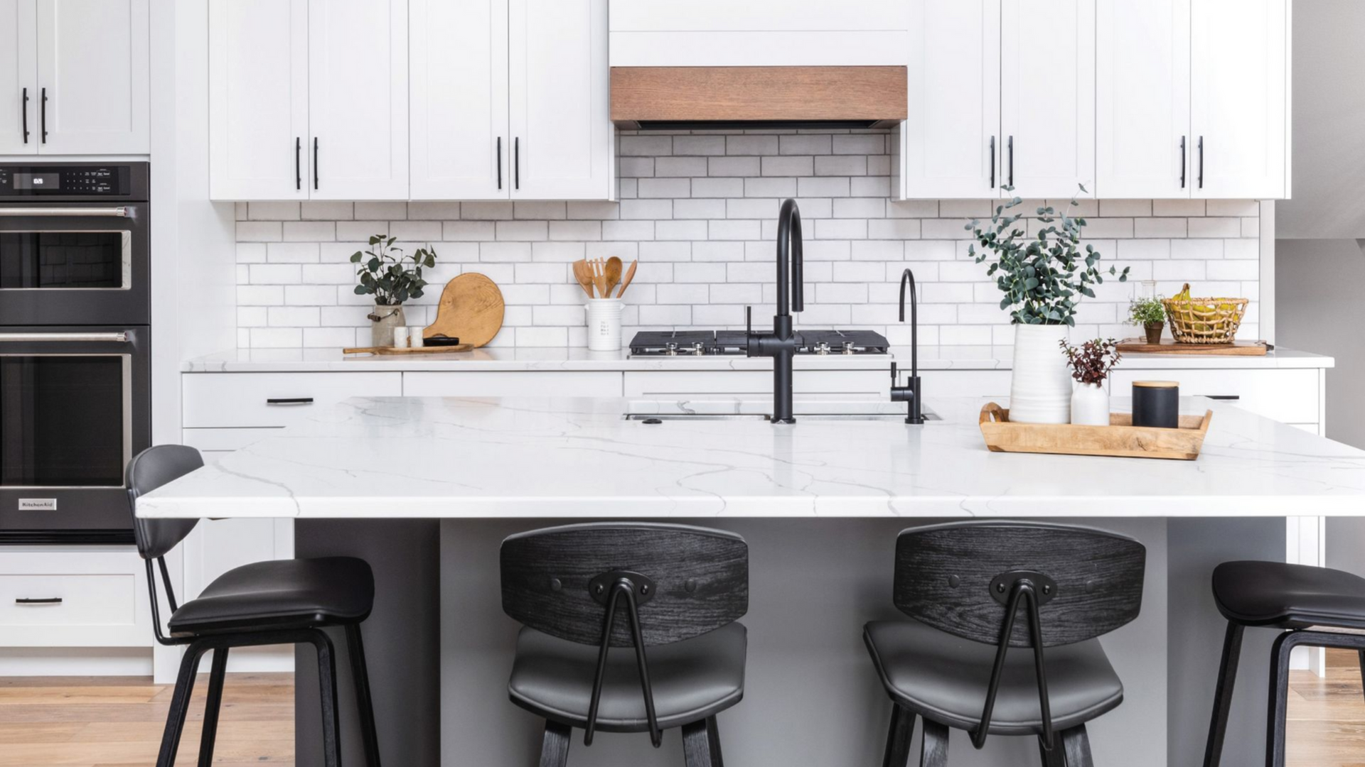 Dark wood double bathroom vanity with gray countertop, mirrors, and a tall cabinet.