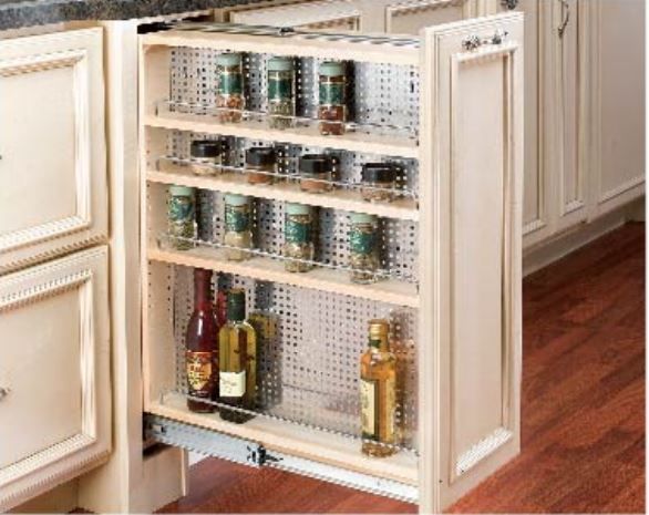 Pull-out kitchen cabinet with wire shelves holding spice jars and bottles of oil, against a wood floor.