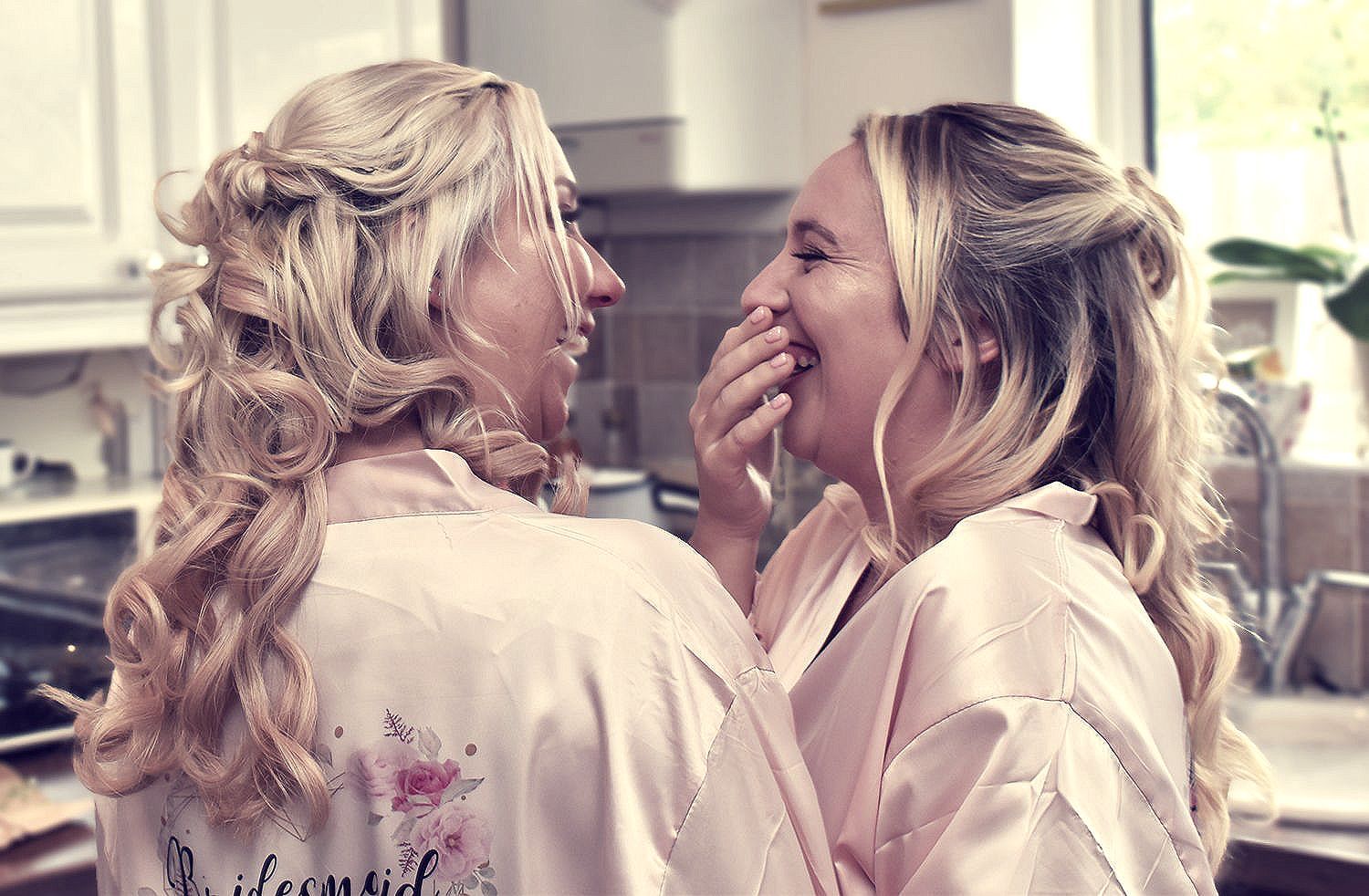 Wedding bridesmaids laughing together and relaxing in Bournemouth.