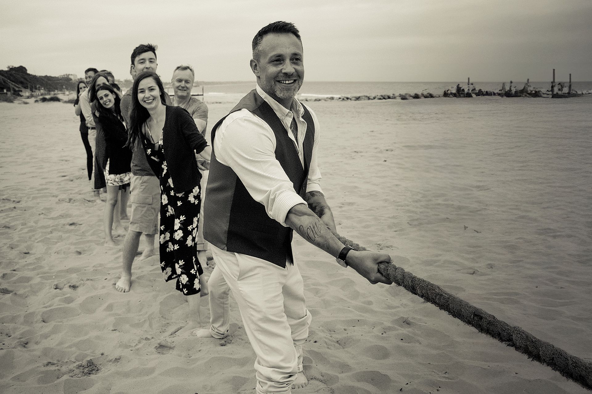 Groom and his family on the beach at his wedding in Bournemouth, Dorset