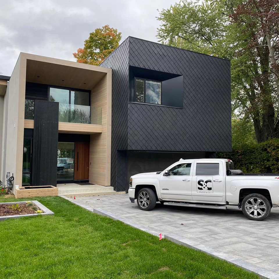 A white truck with the letters sc on the back is parked in front of a house