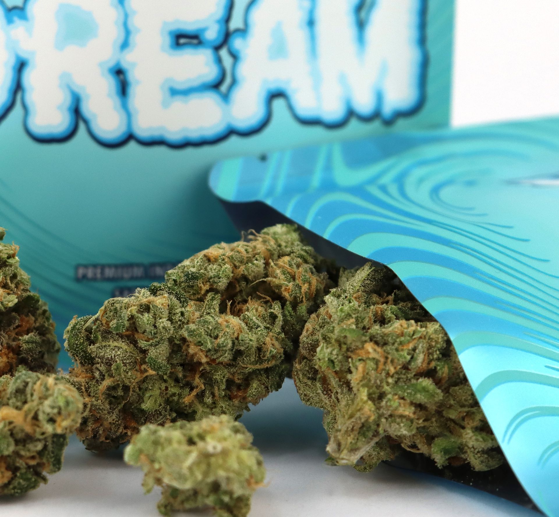 close up of blue dream weed spilling out of packaging