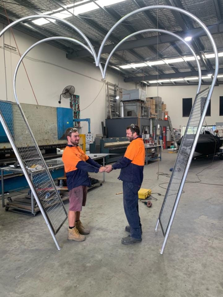 Two Men Underneath Steel Wedding Arch — Sheet Metal Fabrication in Gold Coast, QLD