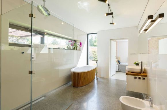 A bathroom with a bathtub , sink , and shower.