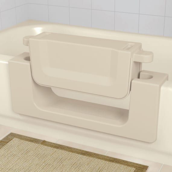 A white bathtub with a white seat attached to it.