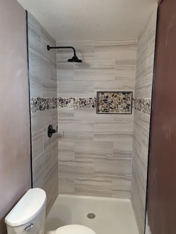 There is a toilet and a shower in the bathroom.