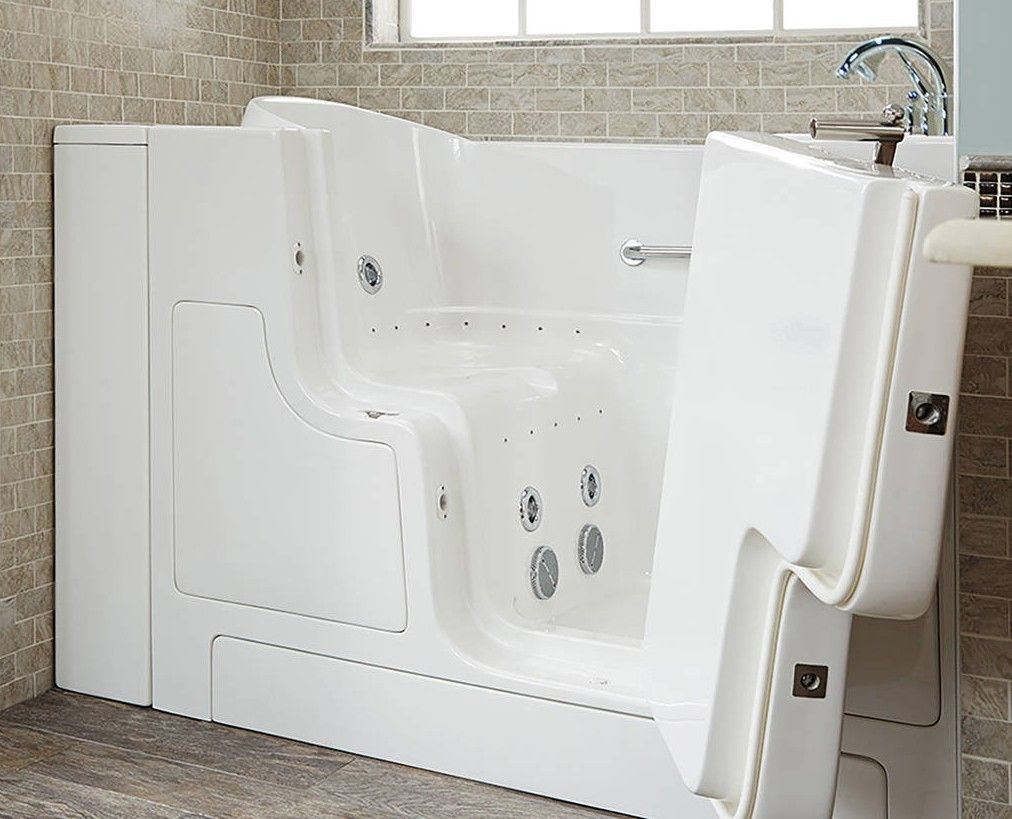 A walk in tub with a door open in a bathroom