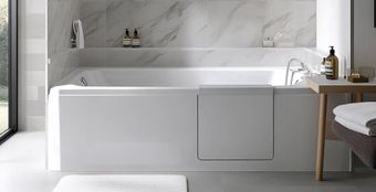A bathroom with a walk in tub with a door.