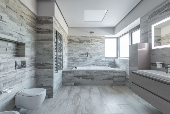 A bathroom with a black tile floor and a black counter top.
