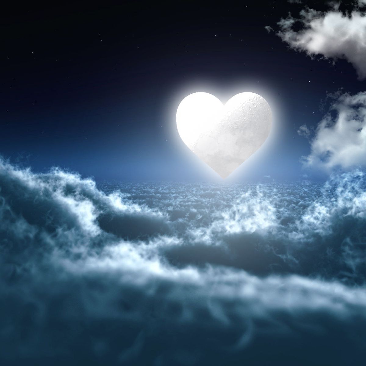 A heart shaped glowing moon in a beautiful night sky with clouds and stars