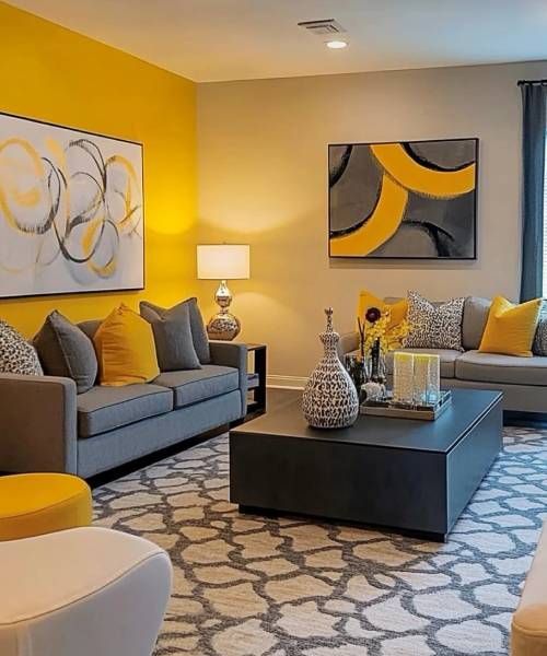A living room with yellow walls , a couch , a coffee table , and a rug.