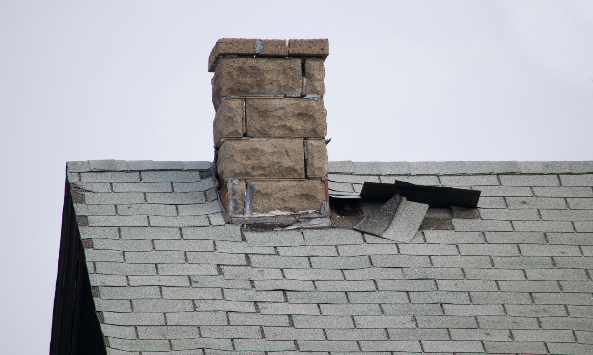 A group of men are working on the roof of a building.