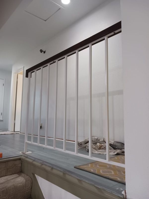 White railing in a room with a rug on the floor — San Jose, CA — DB Remodeling