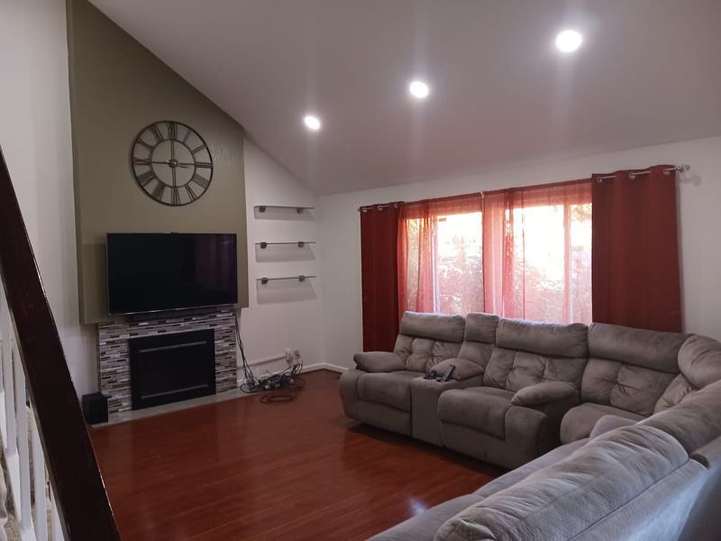 Living room with a clock on the wall above the fireplace — San Jose, CA — DB Remodeling
