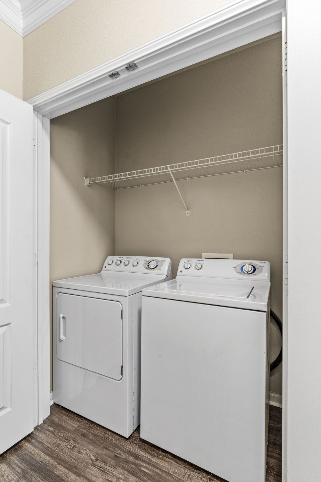 A laundry room with a washer and dryer in a closet at Reserve at Long Point.