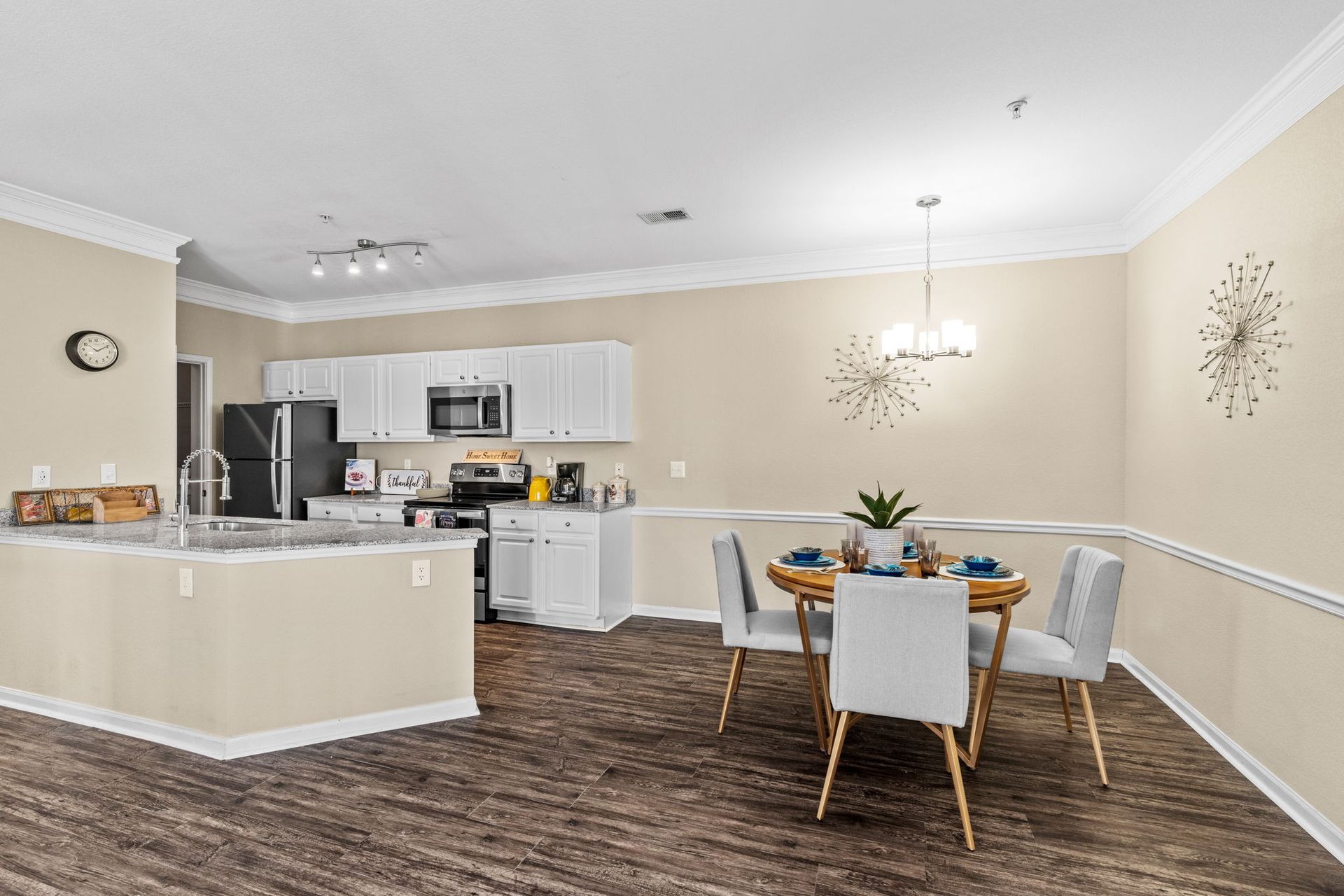 A kitchen and dining room in a house with a table and chairs at Reserve at Long Point.