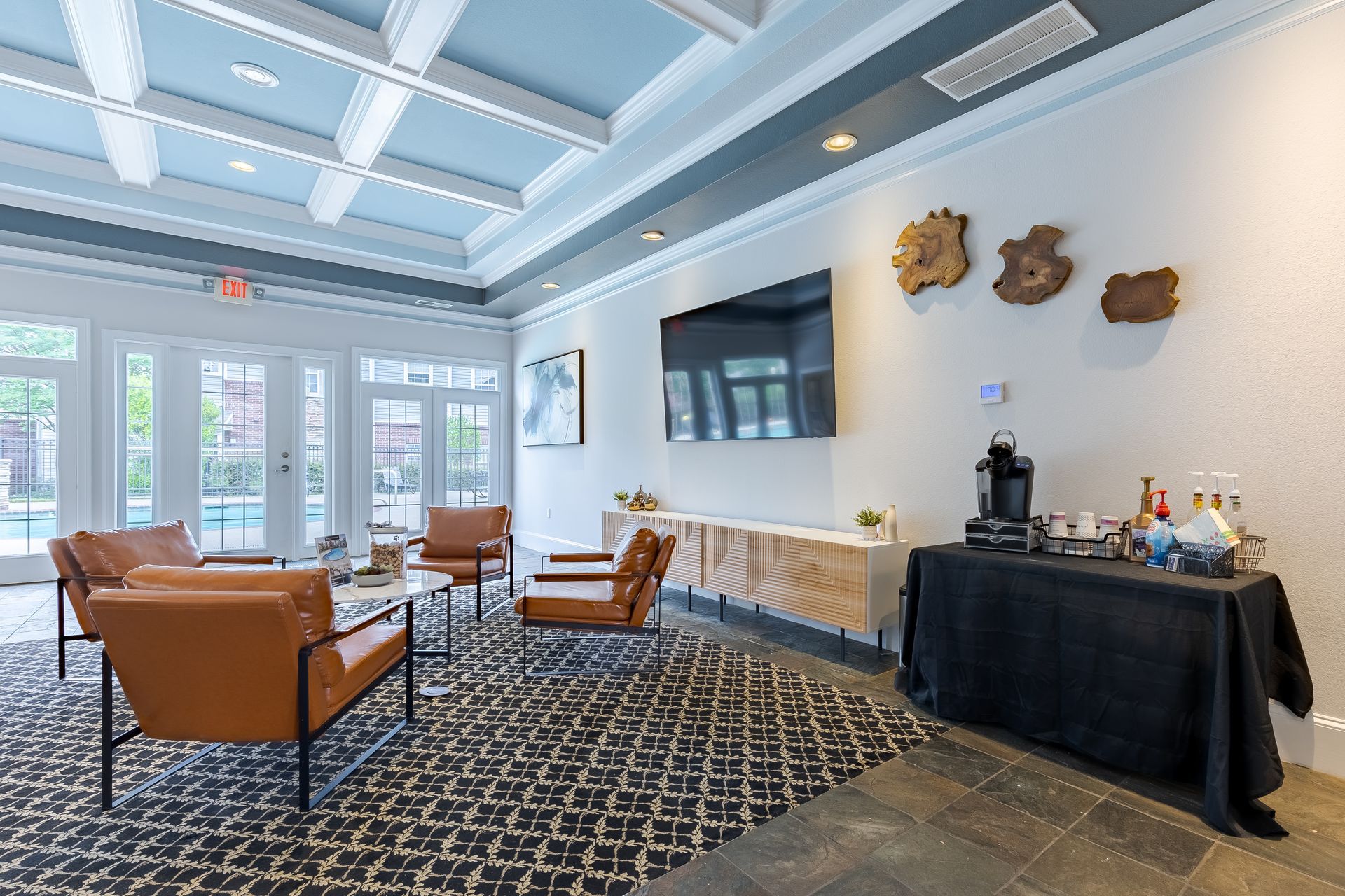 Outdoor patio with pergola, brick fireplace, seating, and round table.