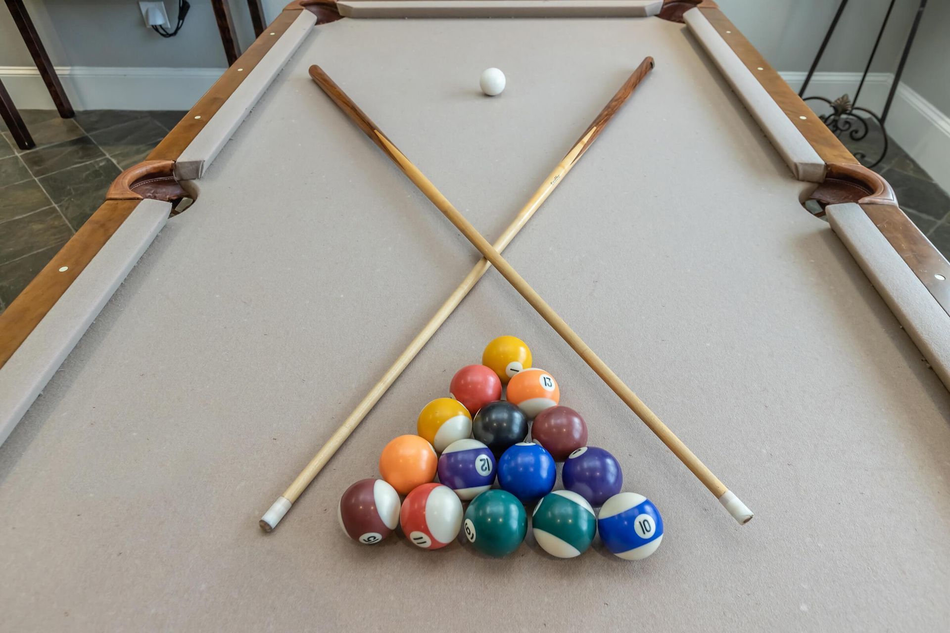 A pool table with balls and cues on it at Reserve at Long Point.