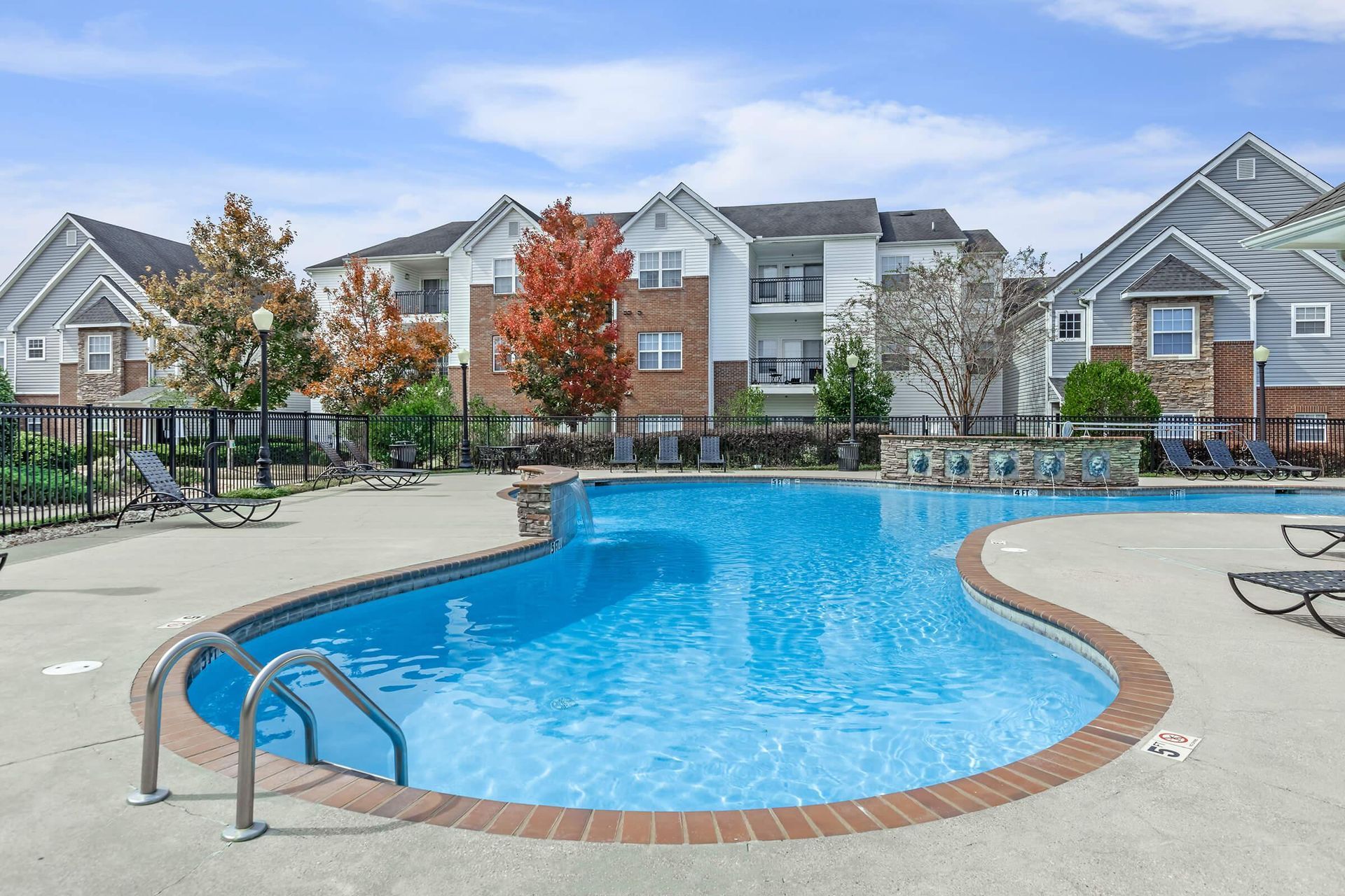 There is a large swimming pool in front of a building at Reserve at Long Point.