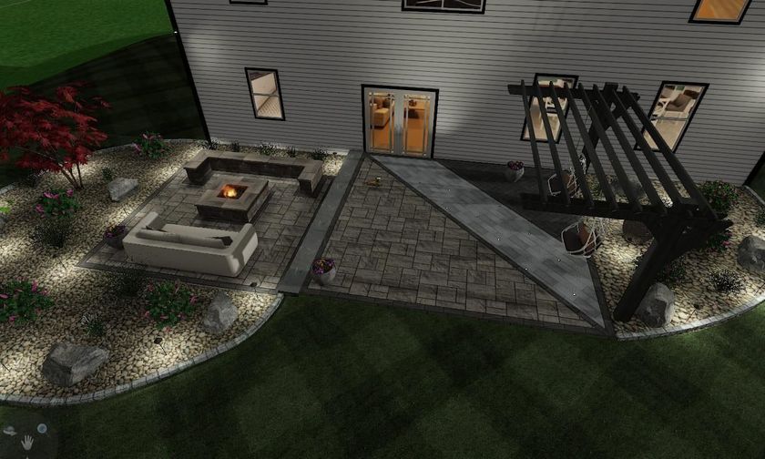 An aerial view of a house with a fire pit in the backyard at night.