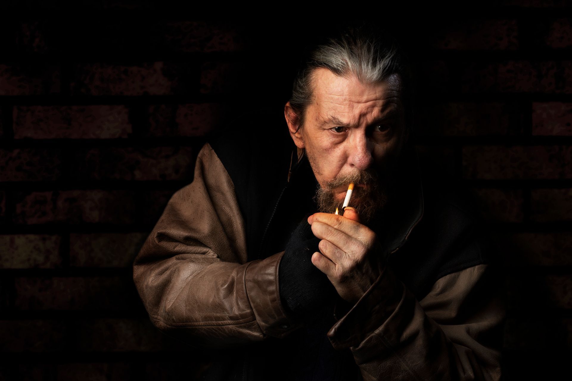 rough, rugged man lighting a cigarette