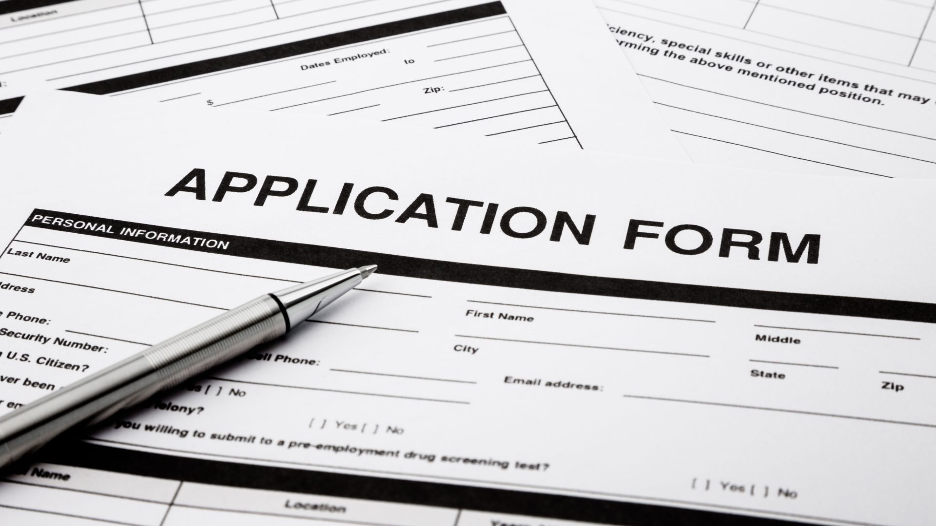 Application form with a pen resting on it.