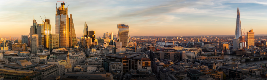 Panoramic cityscape at sunset, featuring modern skyscrapers in London, England.