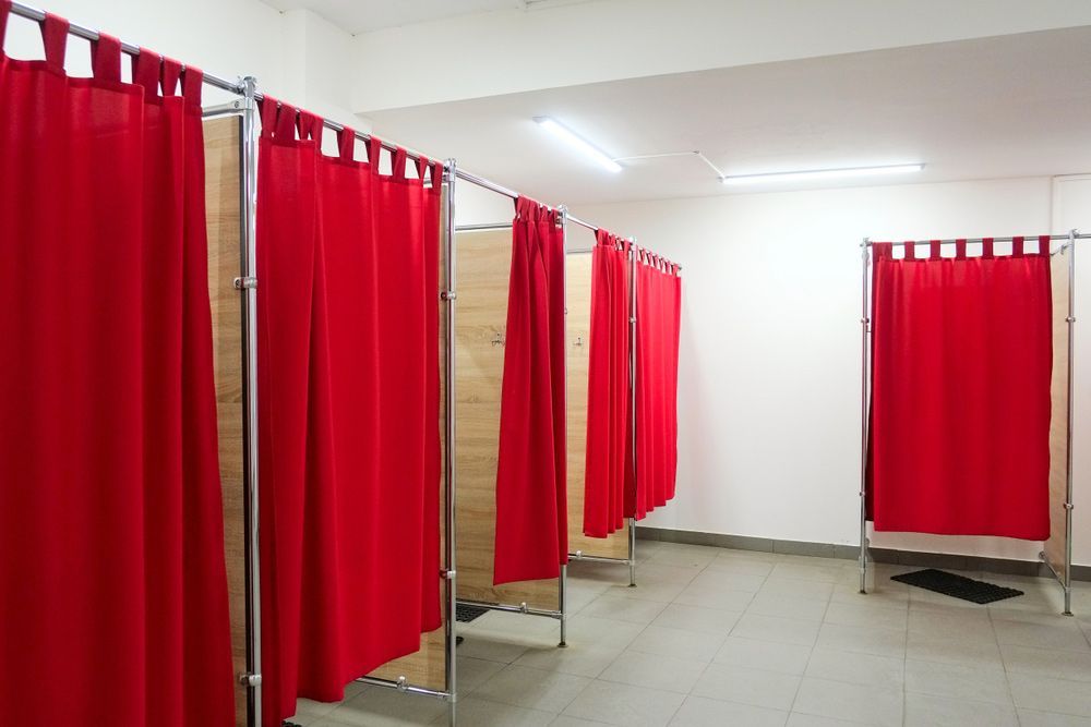 A Row of Dressing Rooms with Red Curtains and Mirrors — FBM Fabrication In Shellharbour, NSW