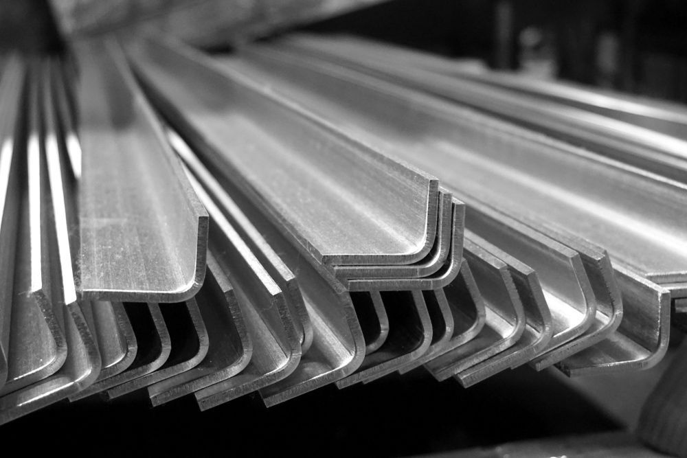 A Black and White Photo of A Stack of Stainless Steel Angles — FBM Fabrication In Nowra, NSW