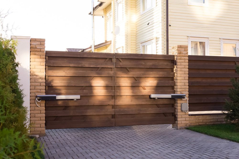 A Wooden Gate Is Open to A Driveway in Front of A House — FBM Fabrication In Wollongong, NSW