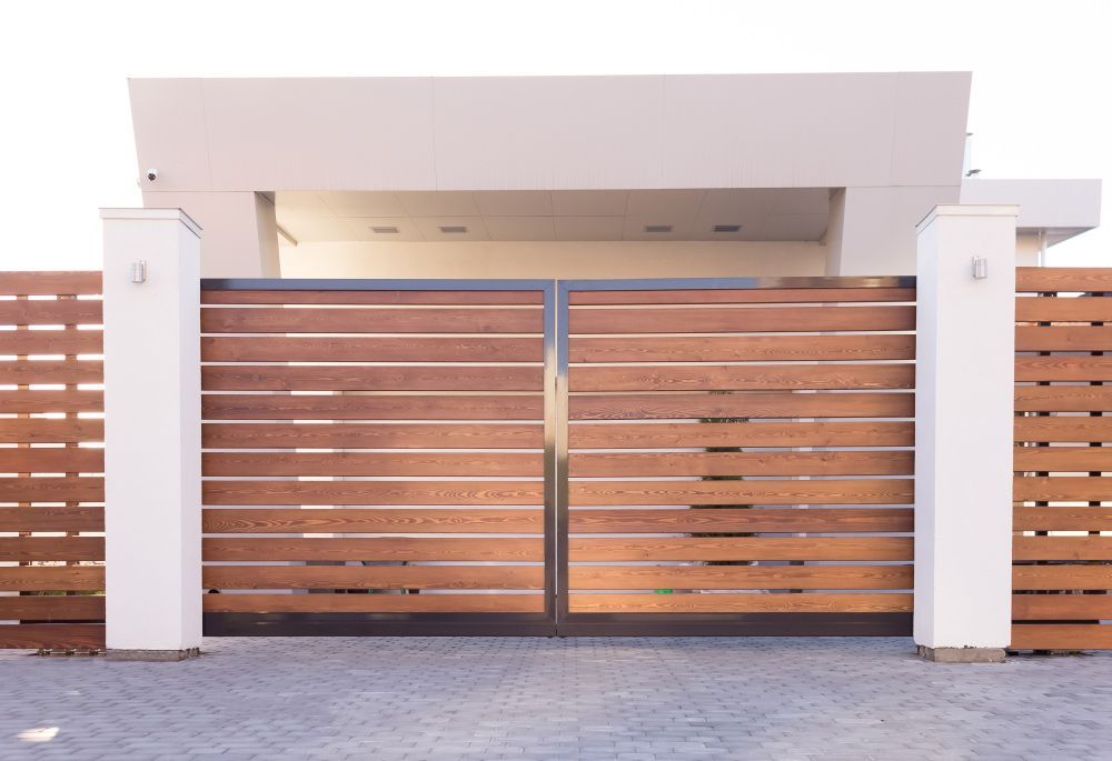 A Wooden Fence Surrounds the Entrance to A House — FBM Fabrication In Nowra, NSW