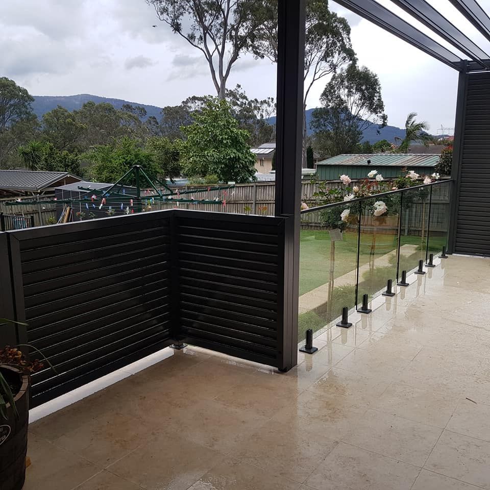 A Canopy with A Clear Glass Roof Is on The Side of A Building — FBM Fabrication In Dapto, NSW