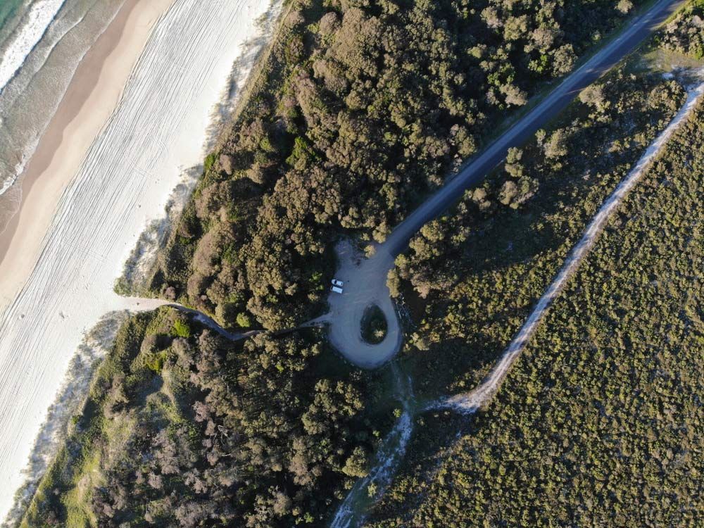 An Aerial View of A Road Going Through a Forest Next to A Beach — FBM Fabrication In Nowra, NSW