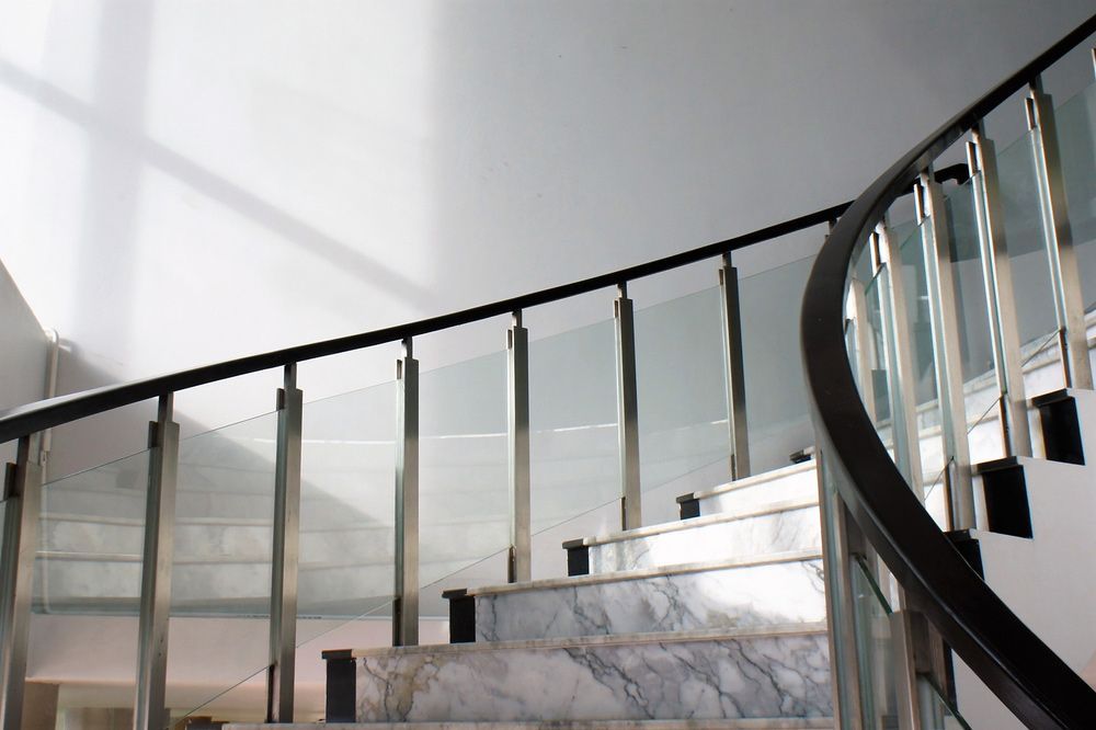 A Staircase with A Glass Railing and Marble Steps — FBM Fabrication In Dapto, NSW