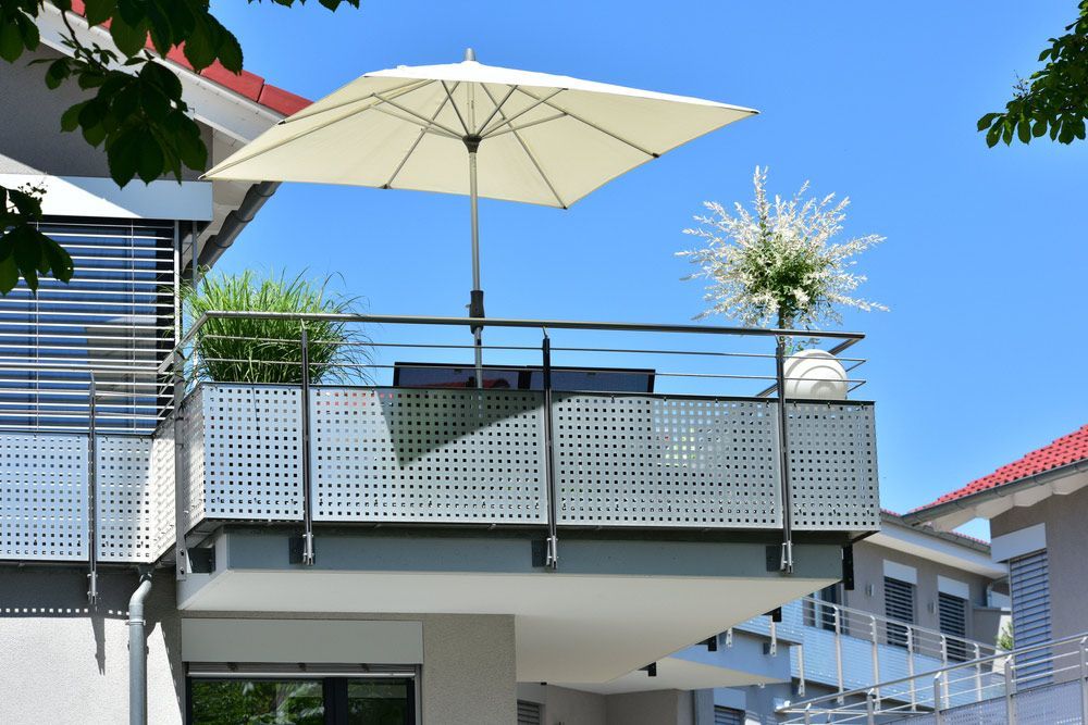 A Balcony with A White Umbrella on Top of It — FBM Fabrication In Dapto, NSW