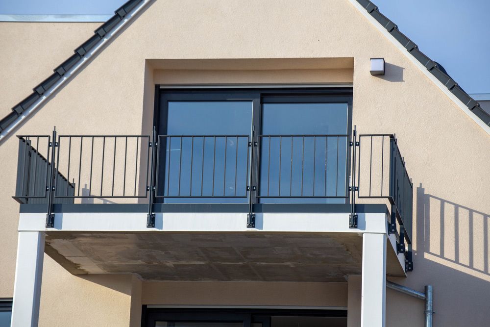 A Balcony on The Side of A House with A Black Railing — FBM Fabrication In Nowra, NSW