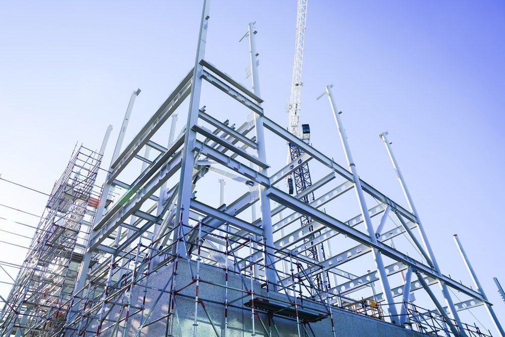 A Large Building Is Being Built with Scaffolding and Cranes — FBM Fabrication In Dapto, NSW